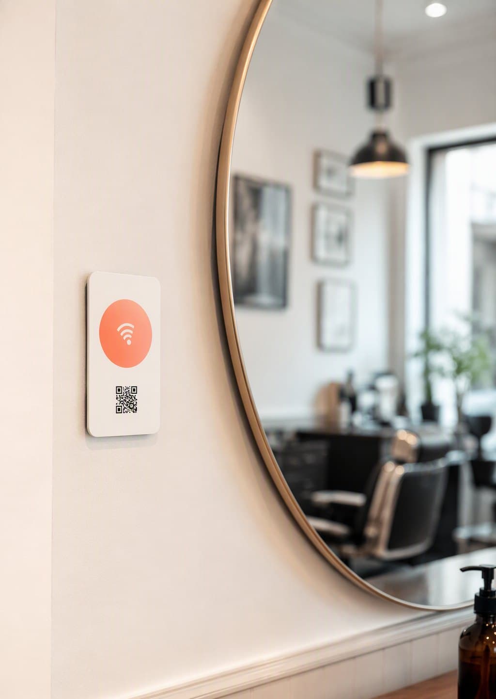 Tappivo mirror plaque mockup mounted beside a salon mirror, white with a coral tap zone